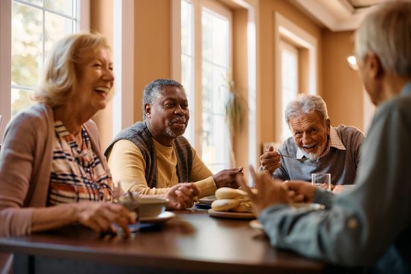 Senior adults enjoying conversation and hot chocolate