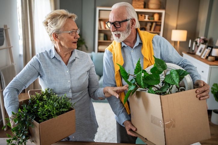 Senior adults boxing up belongings