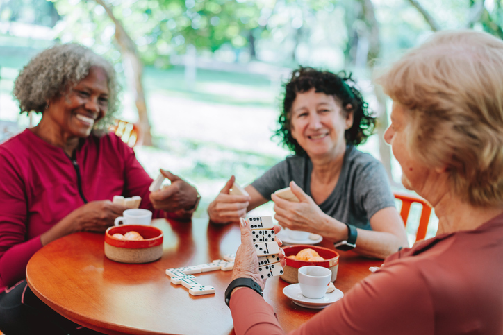 Senior adult women playing a table game