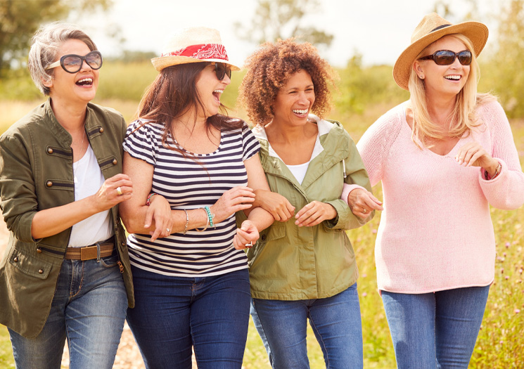 Four women walking in a park