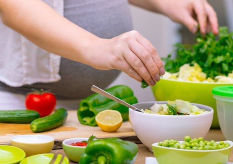 Pregnant woman preparing food