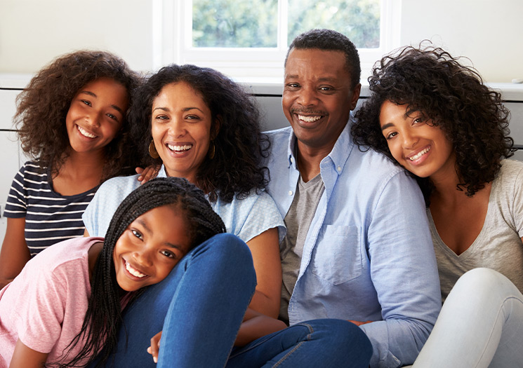 Family sitting on the couch together