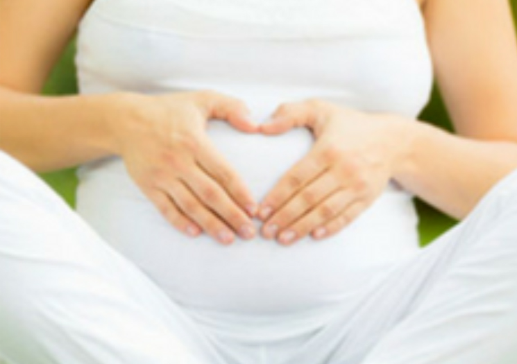 Pregnant woman with hands on belly