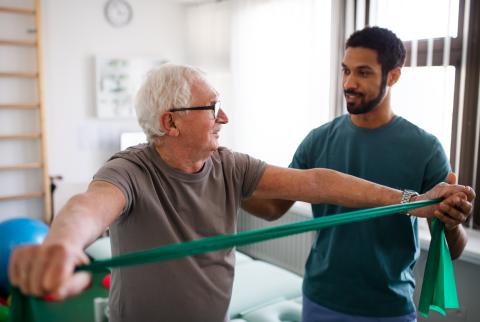 Elderly gentleman receiving physical therapy